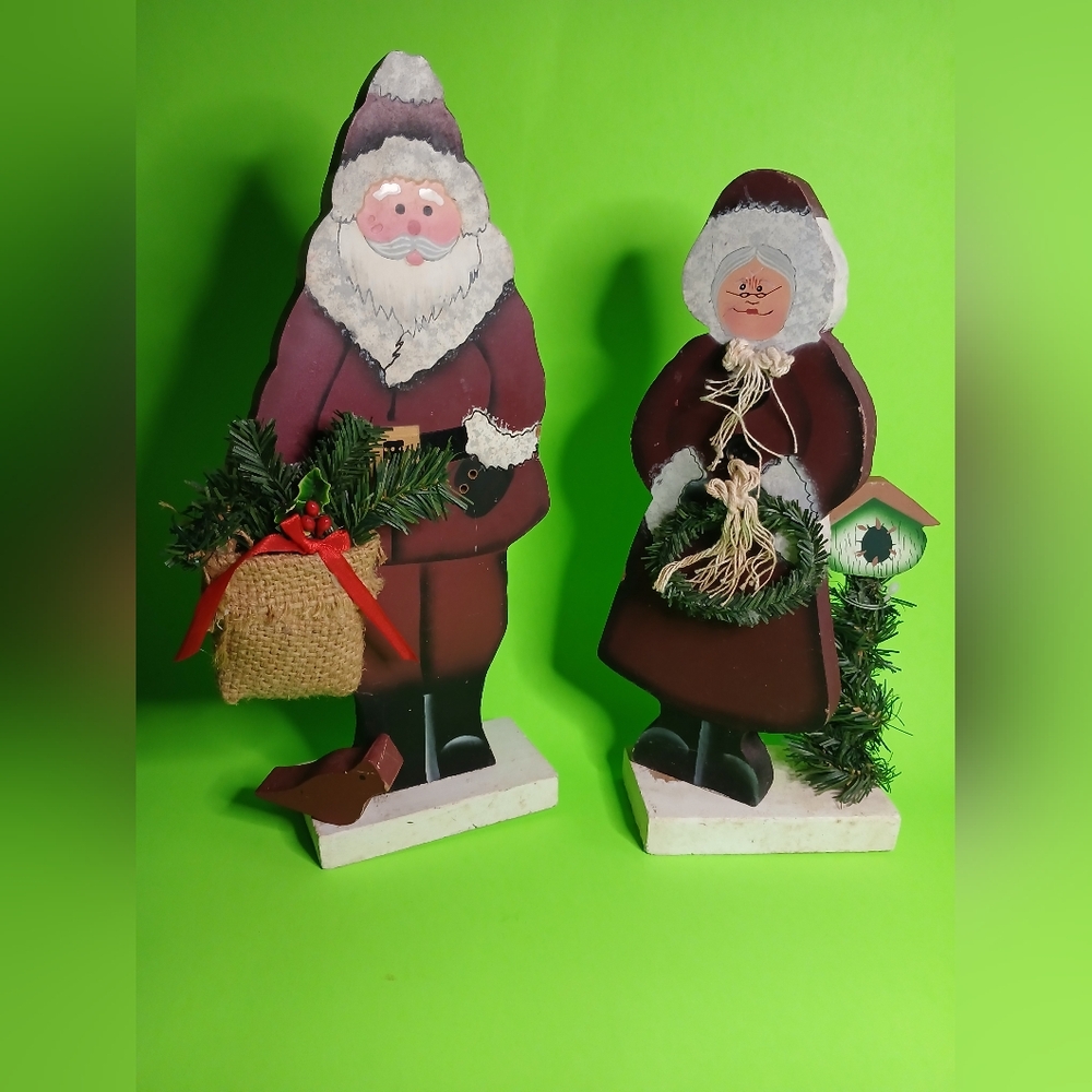 Vintage homemade and hand painted wooden Santa Clause and Mrs Clause